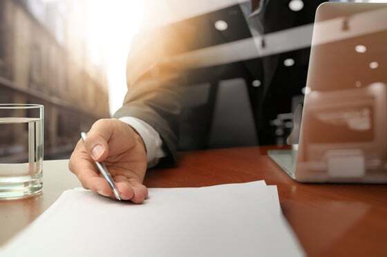 Signing a contract at a desk